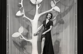 Black and white image of a woman modeling nylon stockings in an exhibit at the New York World's Fair