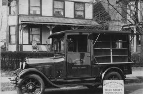 Black and white photo of a bookmobile, circa 1920s, run by the Delaware State Library Commission. 