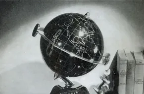 Black and white photo of a globe sitting on a surface.