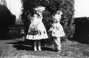 Black and white photograph of two children in Easter costumes with baskets.