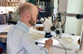 Luke Kelly conserving paper document at the Hagley Library