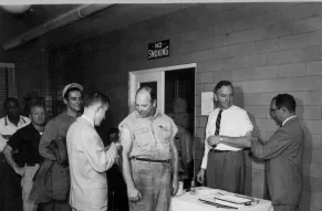 Photograph of Westinghouse employees receiving influenza A (H2N2) shots at the dispensary
