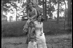 Glass negative showing six children arranged into a tower formation.