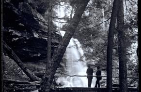 View of two people on a bridge over an unidentified waterfall, probably at Glen Onoko, possibly the cascade above Sunrise Point.