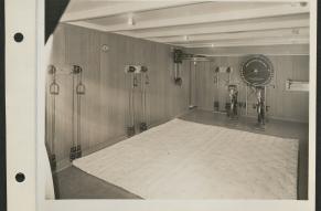 Black and white image of a fitness room with workout equipment on board the S.S. Lurline.