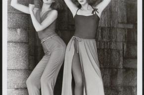 Black and white photograph of two women modeling "Disco Bodywear"