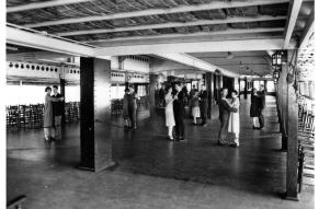 Black and white image of dancers paired off in the ballroom of a ship.