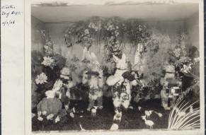 Black and white image of an Easter themed department store show window; bunnies with musical instruments.
