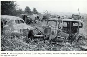 Black and white photograph of scrapped automobiles after being burned.