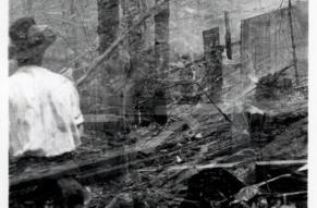 View of wreckage after a wheel mill explosion in Hagley Yard, with man standing in foreground.