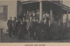 Black and white photograph of an interracial group of educators and their spouses on a porch.