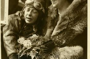 Photograph of a woman pilot hugging an older woman (her mother).